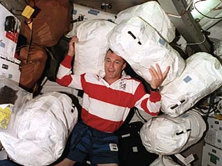 STS-79 mission pilot Terry Wilcutt is surrounded by water transfer bags in the Atlantis's middeck. These bags will eventually be used to transfer water to the Mir space station. 